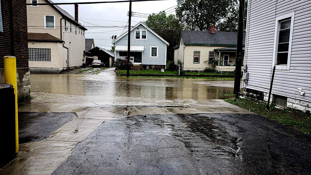 Water pooling near the foundation of a home due to poor drainage.