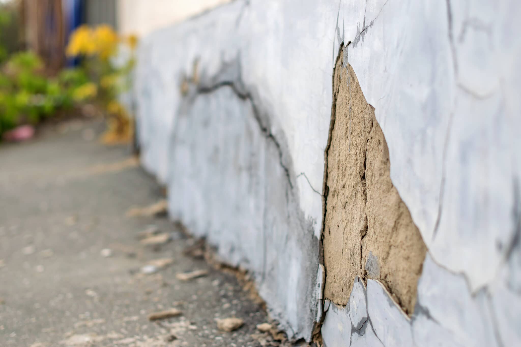 Water leaking through cracks in a home’s foundation.