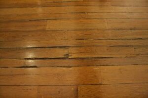 Warped hardwood flooring caused by water damage in a DFW home.