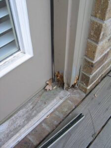 Rotting wood on a window frame in a Texas home caused by water damage.